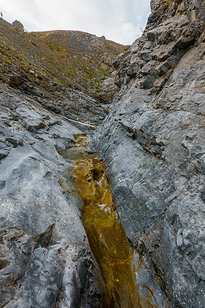 The creek runs over smooth rocks. It was surprisingly high given no glacier or snow to feed it.