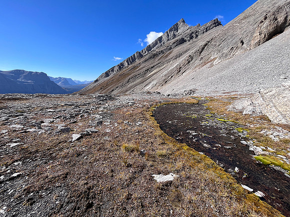Traversing rubble and scree slopes west towards False Allenby.