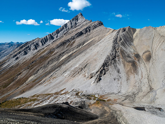 Traversing rubble and scree slopes west towards False Allenby.