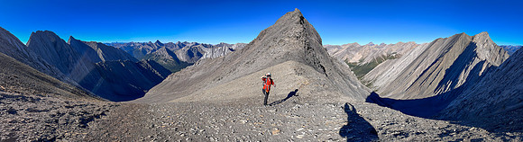 Ascending south scree slopes to the upper col under the west face.