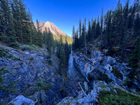 A scenic waterfall near the Flints Park campground with the North Cascade River flowing towards the Cascade River.