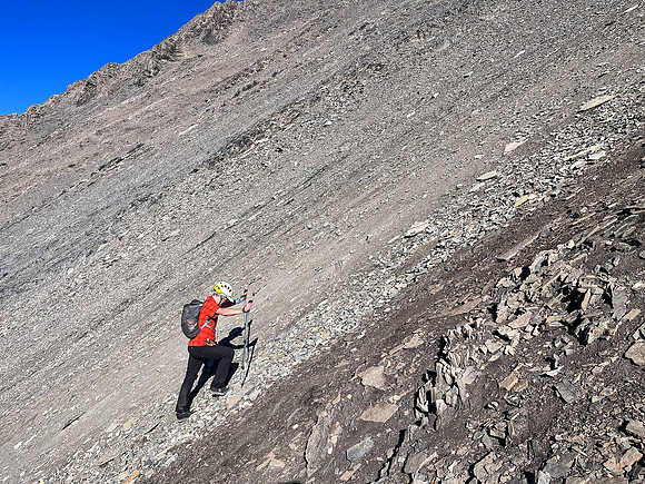 Ascending south scree slopes to the upper col under the west face.