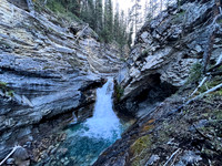A scenic waterfall near the Flints Park campground with the North Cascade River flowing towards the Cascade River.