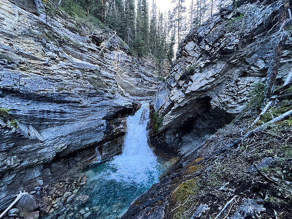 A scenic waterfall near the Flints Park campground with the North Cascade River flowing towards the Cascade River.