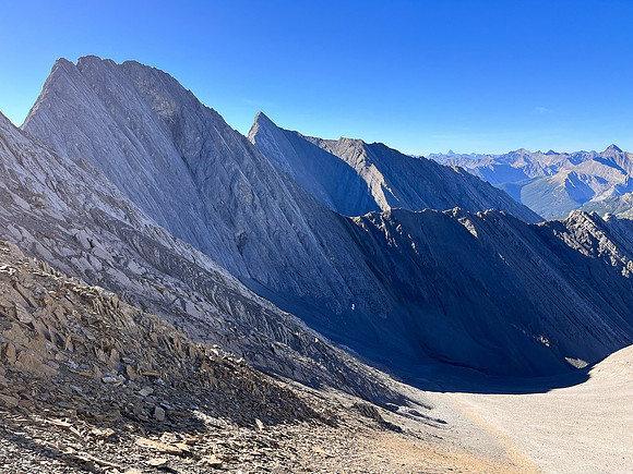Ascending south scree slopes to the upper col under the west face.