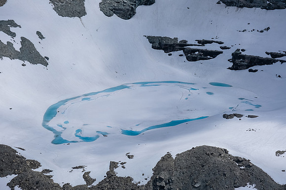 A nice tarn tucked under Talon Peak.