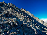 Continuing on looser terrain to the summit - still traversing under the SE ridge proper.