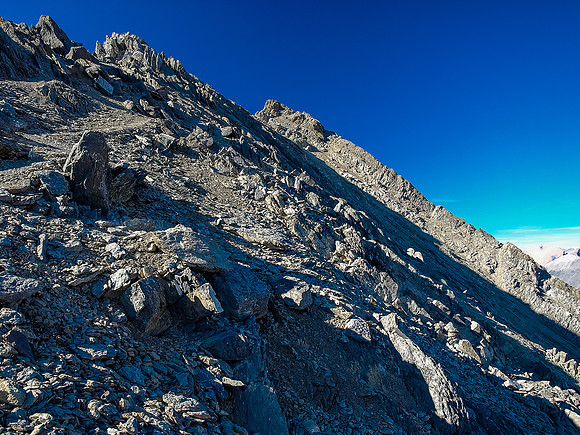 Continuing on looser terrain to the summit - still traversing under the SE ridge proper.