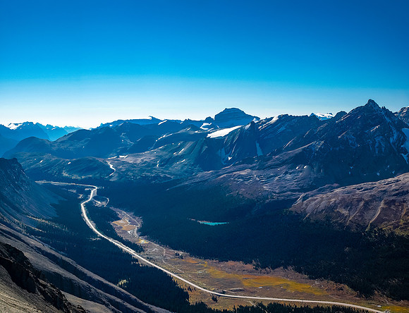 View to the south down hwy 93 with Mount Saskatchewan stealing the show above and a brilliant tarn stealing the show below.