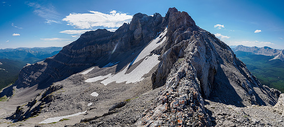 Descend here to the right avoid the NW ridge and traverse rubble slopes under the false summit left.