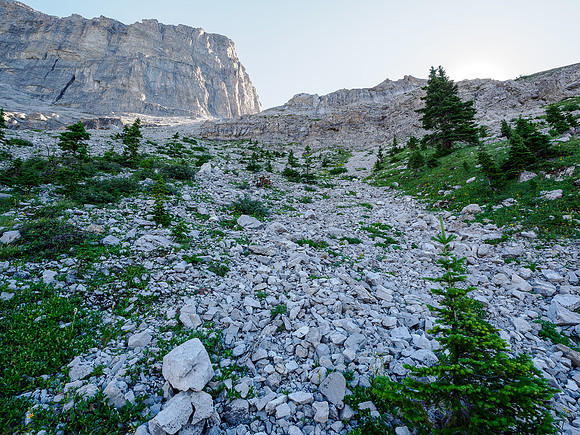 Hiking the boulder field under the col.