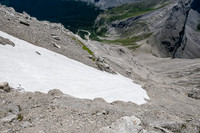 Traversing above a giant snow patch on the face.