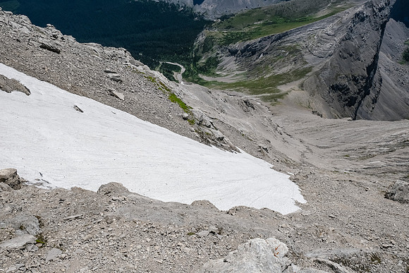 Traversing above a giant snow patch on the face.