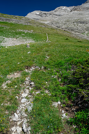 Ascending steeply to the pass under Tornado's SW face.