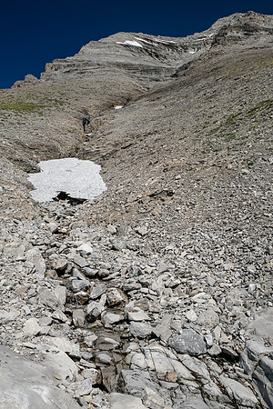 Ascending the lower rubbly SW gully / face of Tornado Mountain.