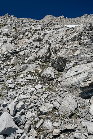 Loose rubble and low cliffs to the summit.