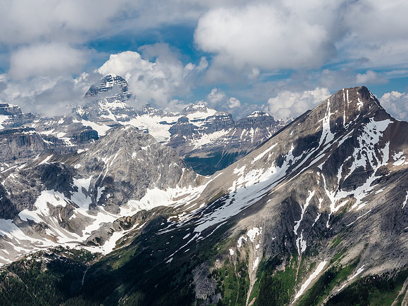 Mount Assiniboine towers of Mount Aurora at left while Mount Byng rises at right across the Currie Creek Valley.