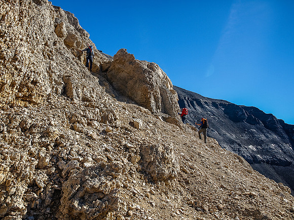 The obvious gray band rock starts to show up above us now as we traverse towards the crux.