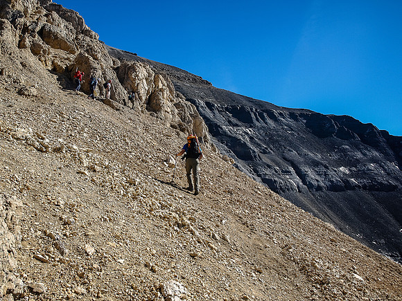 The obvious gray band rock starts to show up above us now as we traverse towards the crux.