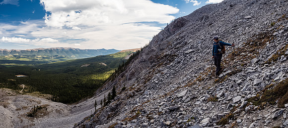 Looking back up the upper scree ramp with our treed ledge ascent route at mid-center.