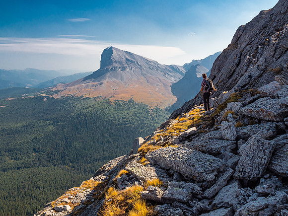 Phil traverses a ledge on the east face with a great view of Beehive Mountain.