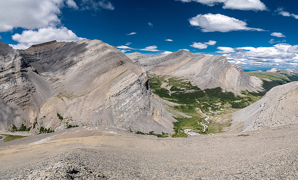 Descending west rubble slopes into the headwaters of Scalp Creek. Views of Tomahawk Mountain.