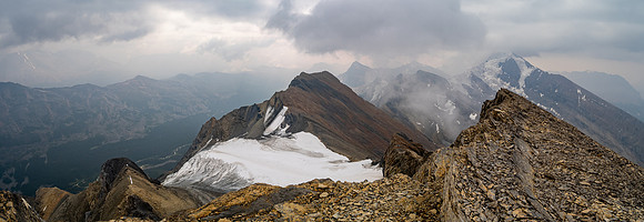 Dark clouds and smoke make for a dramatic scene towards the 3315m Sunwapta Peak with its striking north face. Jonas Creek far below at lower left.