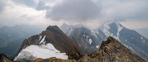 Dark clouds and smoke make for a dramatic scene towards the 3315m Sunwapta Peak with its striking north face. Jonas Creek far below at lower left.
