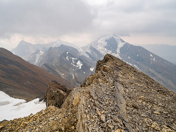 Dark clouds and smoke make for a dramatic scene towards the 3315m Sunwapta Peak with its striking north face. Jonas Creek far below at lower left.