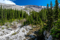 We traverse around the cliffs and descend to this creek...