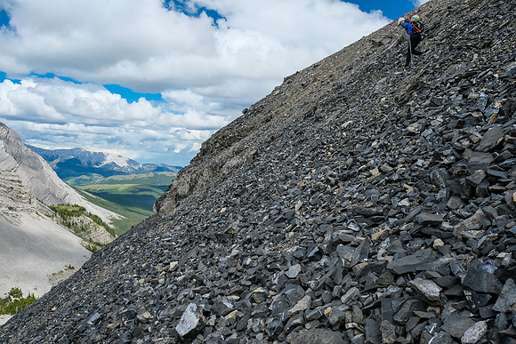 Continuing down steep scree slopes into a small hanging valley.