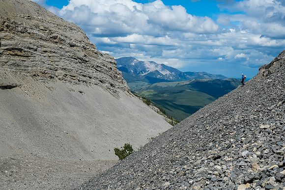 Continuing down steep scree slopes into a small hanging valley.