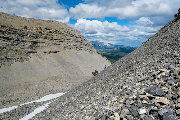 Continuing down steep scree slopes into a small hanging valley.