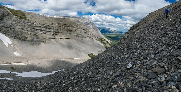 Continuing down steep scree slopes into a small hanging valley.