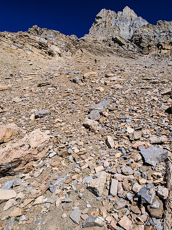 Looking left of the previous photo, Wietse is gaining height on loose scree to the upper mountain - he will soon traverse back to the right.