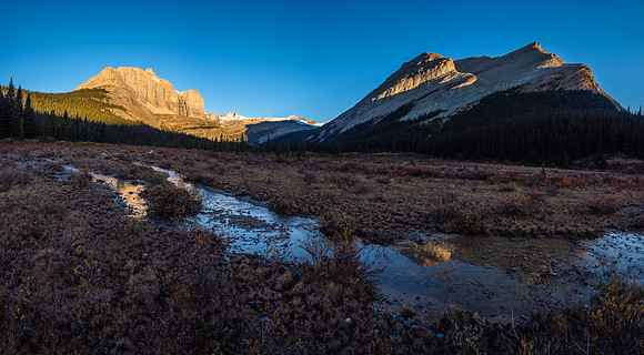 A beautiful early morning view of Pipestone Mountain and its impressive east face (L) and Mount Drummond (R) from Shingle Flats.
