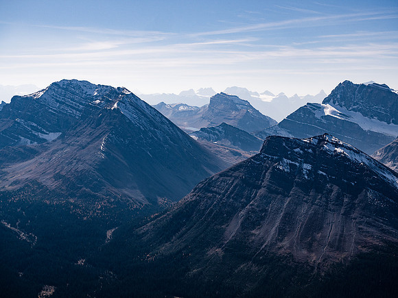 Looking in between Fossil (L) and Skoki (R) peaks over Packer's Pass Peak towards Redoubt Mountain with Ptarmigan rising at right.