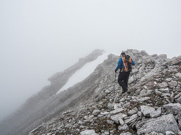 Kev traverses the summit ridge with the summit cornice in between us and the top.