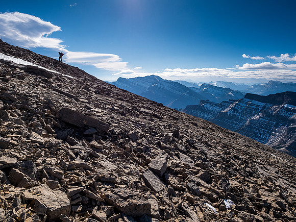 Trevor on the endless southwest slope of Castle Rock with the giant Costigan in the distance.