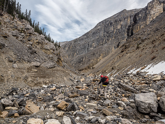 Forging ahead into the unknown! Trevor heads up valley towards menacing cliffs coming down off Castle Rock.