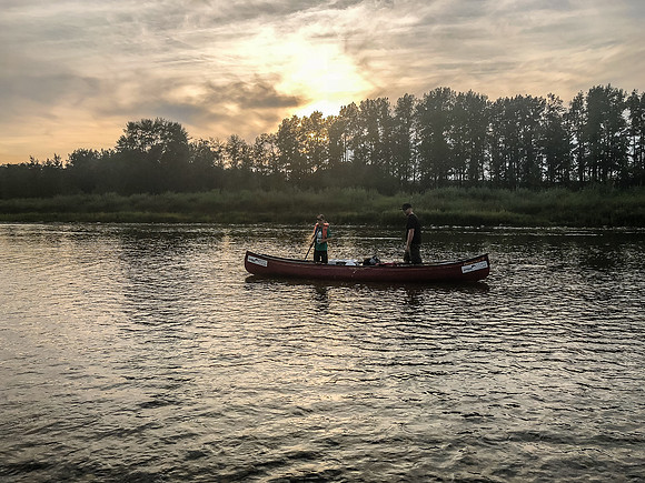 Mike and Carter are out of the boat due to a very shallow section of river.