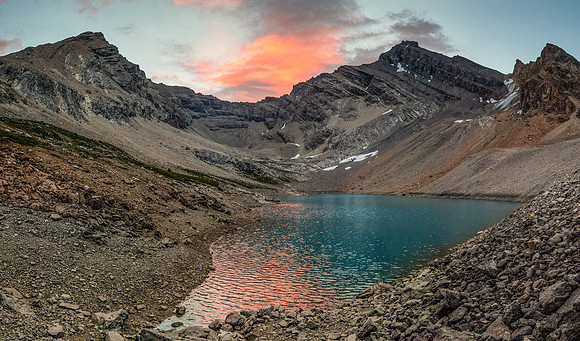Recondite (L) and Augusta (R) reflect in the alpine tarn near our bivy site.