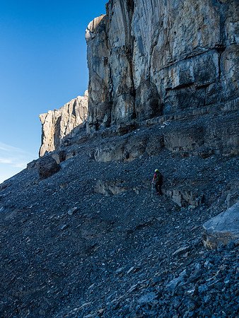 Traversing the headwall to an obvious weakness on climber's left.