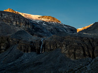 We are out of the suck and near valley bottom as the sun rises and kisses the Hector Glacier far above us now.