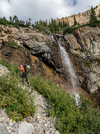 Phil ascends rubble slopes to the first headwall.