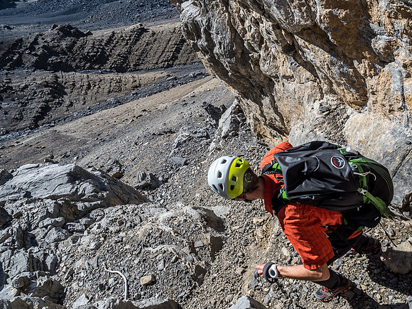Navigating the loose gully that breaks through the lower cliff band.