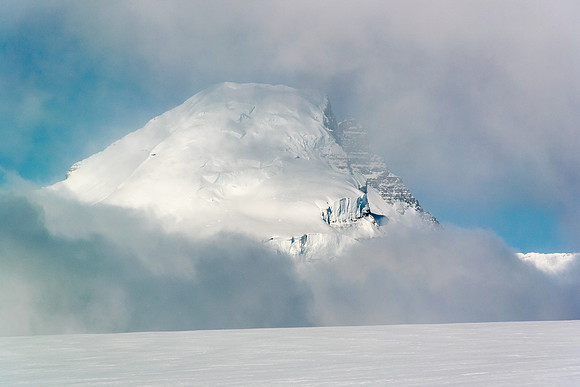 Our giant destination looms ominously in the clouds many kilometers distant beyond the trench.
