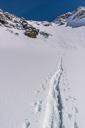 Getting away from the steep slopes, looking back at Ferenc exiting the face to the AA col.