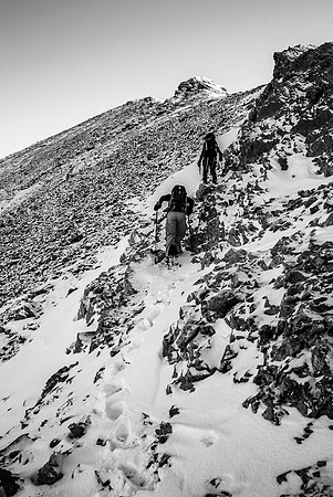 Avoiding slick slabs by traversing up on climbers left.