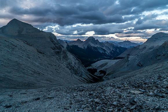 Heading down from the col in growing darkness with Splendid Peak at center distance.